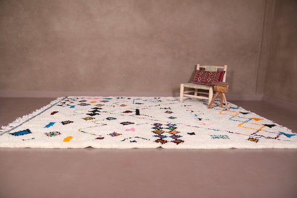 Custom white Moroccan rug with berber-inspired colorful patterns