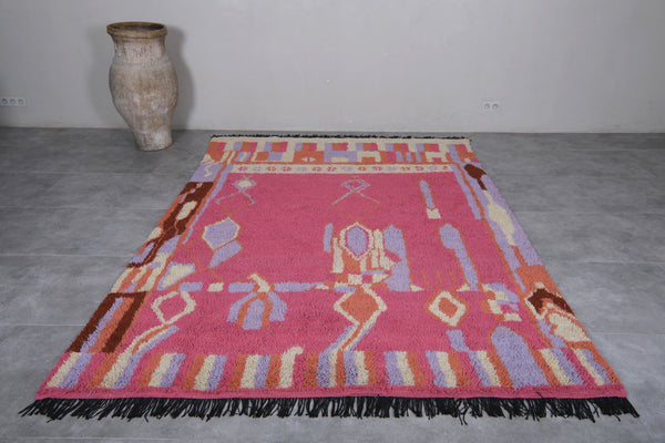 Vibrant pink Moroccan rug with multicolored patterns