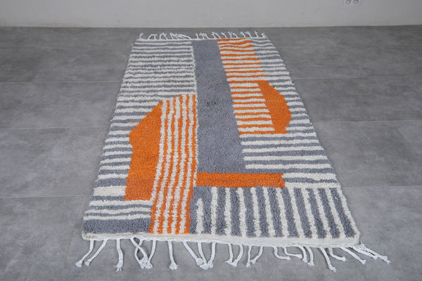 Custom Moroccan wool rug with grey, white, and orange patterns
