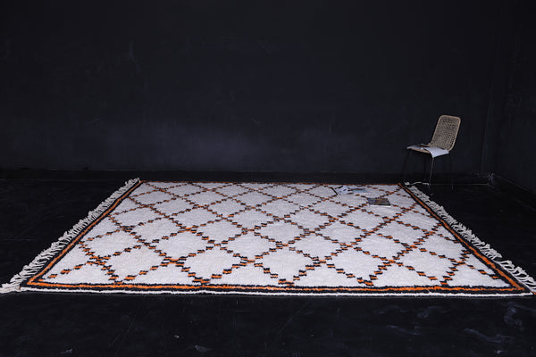 Chic white Moroccan rug with orange patterns