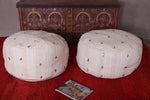 Two round handmade berber moroccan woven poufs